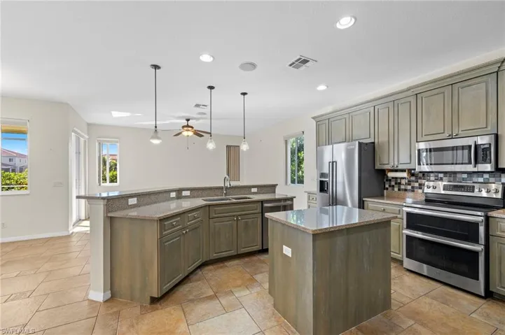 Spacious kitchen with breakfast bar and dining area