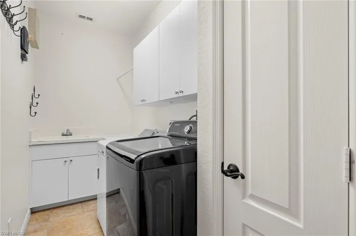 Laundry room with separate sink/cabinet and storage