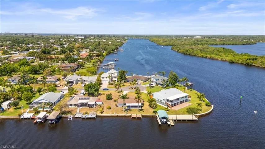 Aerial perspective of suburban area featuring a nearby body of water