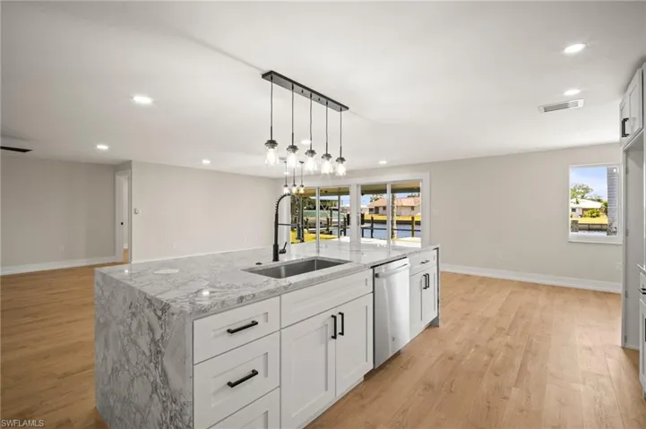 Kitchen with a sink, recessed lighting, light wood-style flooring, and dishwasher