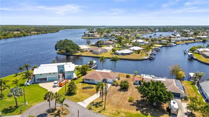 Aerial view of residential area featuring a nearby body of water