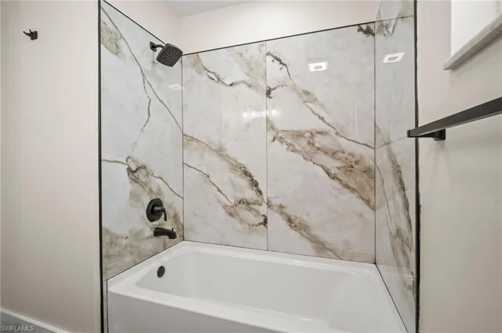 Full bathroom featuring washtub / shower combination