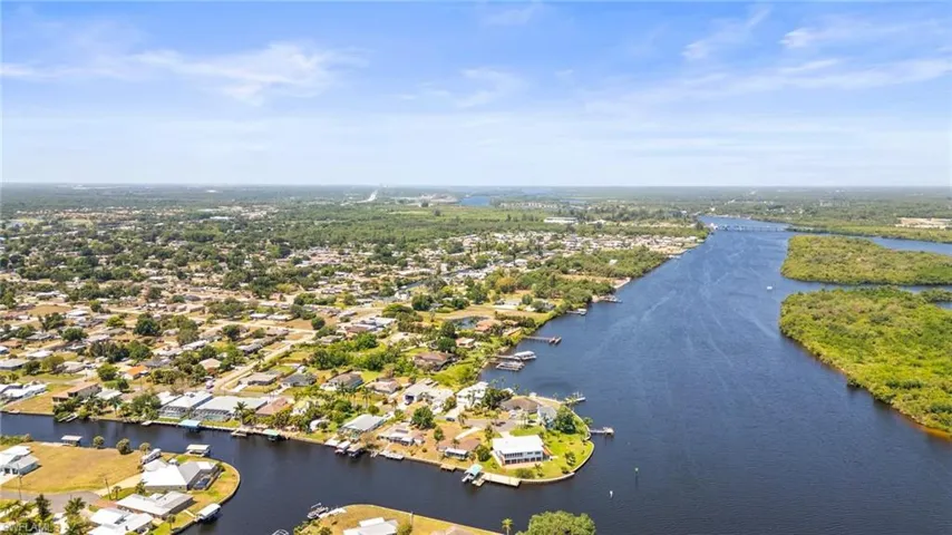 Aerial perspective of suburban area featuring a large body of water