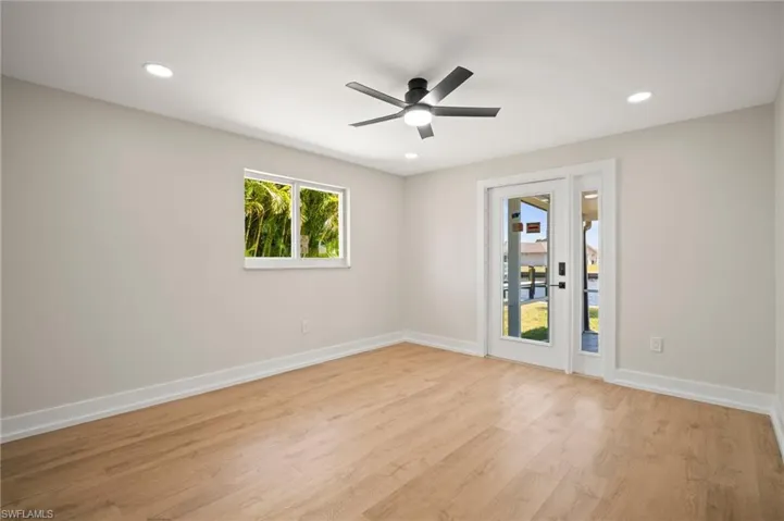 Empty room with ceiling fan, baseboards, light wood-type flooring, and recessed lighting