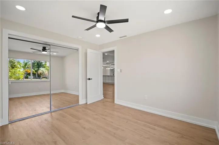 Unfurnished bedroom with baseboards, recessed lighting, light wood-style flooring, and visible vents