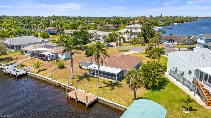 Aerial perspective of suburban area featuring a nearby body of water