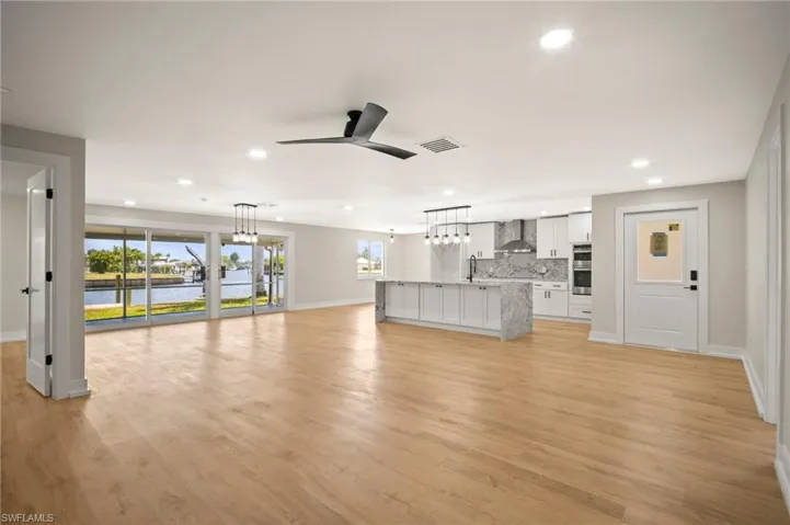 Unfurnished living room featuring baseboards, recessed lighting, visible vents, and a ceiling fan