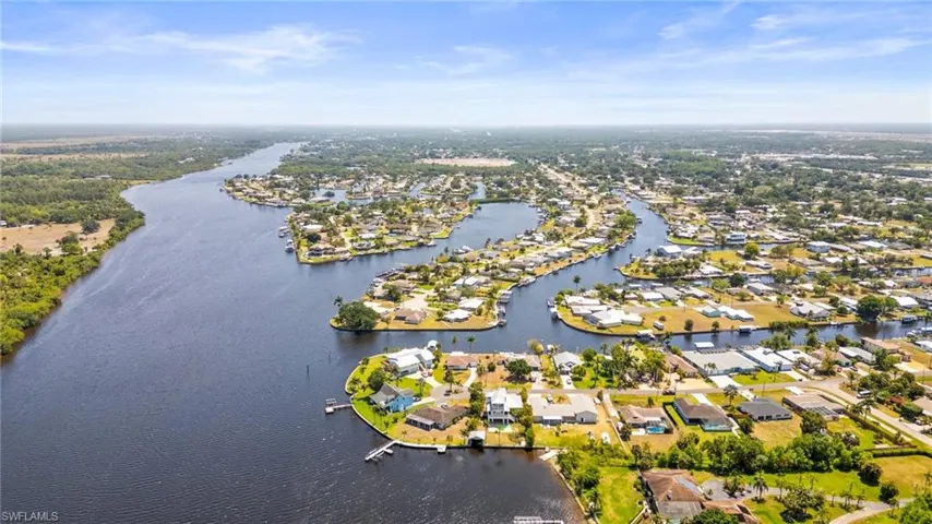 Aerial perspective of suburban area with a large body of water
