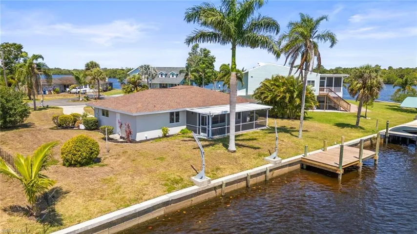 Dock with a water view, a lawn, and a residential view
