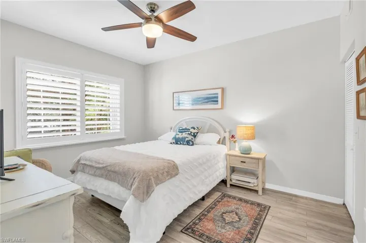 Bedroom featuring light hardwood / wood-style floors and ceiling fan