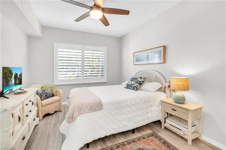 Bedroom featuring ceiling fan and light hardwood / wood-style floors