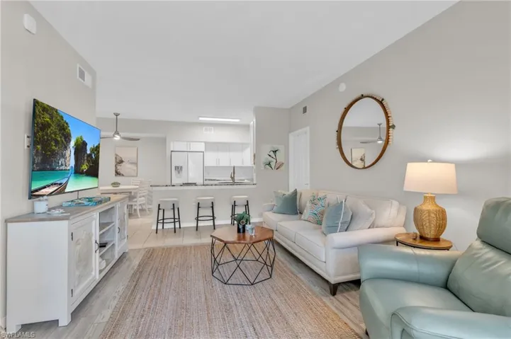 Living room featuring ceiling fan, light hardwood / wood-style floors, and sink
