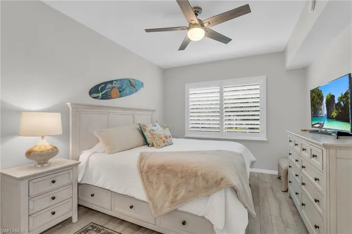 Bedroom with ceiling fan and light wood-type flooring