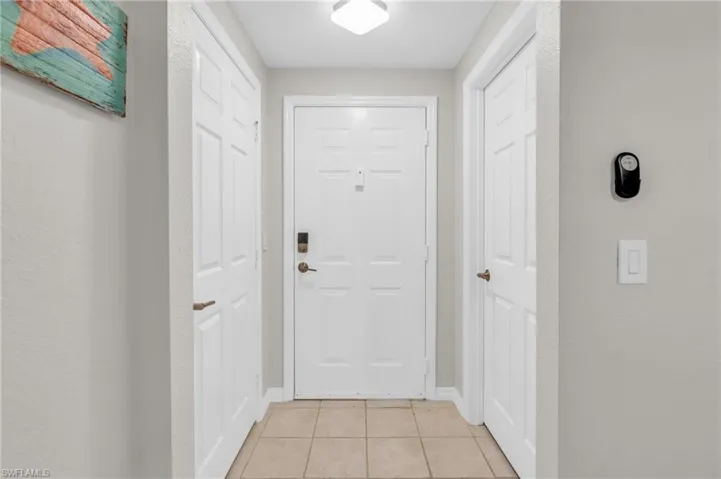 Entryway with light tile patterned floors