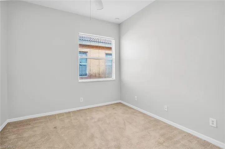Spare room featuring carpet floors and ceiling fan