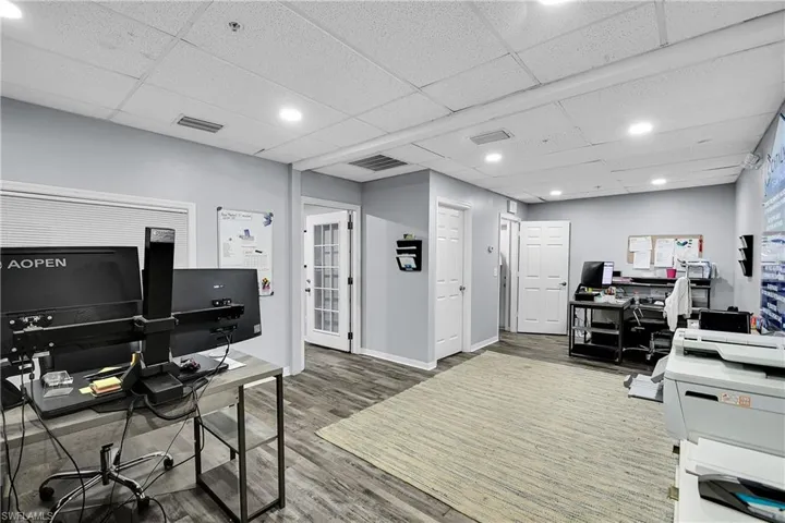 Spacious interior with wood-finish flooring and light gray painted walls