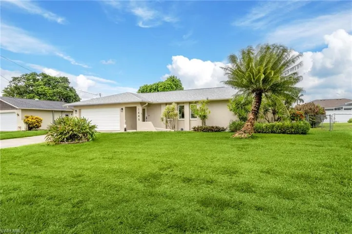 Ranch-style house with a front lawn and a garage
