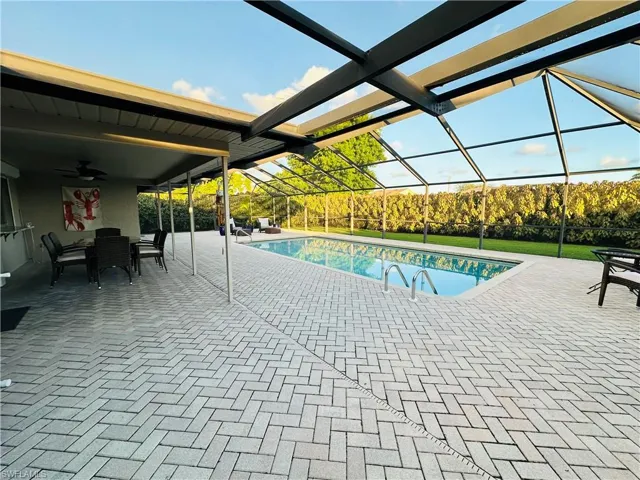 View of swimming pool with a patio and ceiling fan