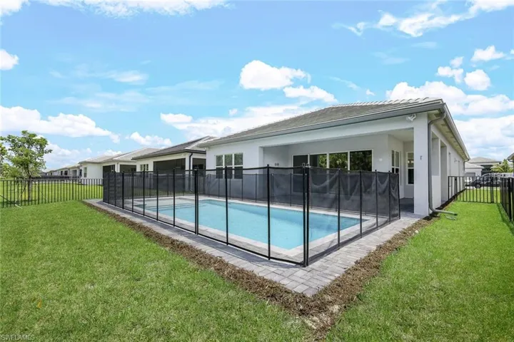 View of pool featuring a yard