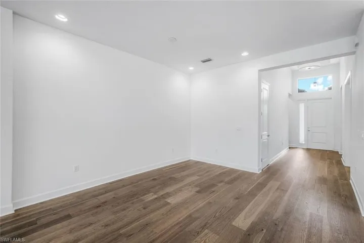 Unfurnished room featuring dark wood-type flooring