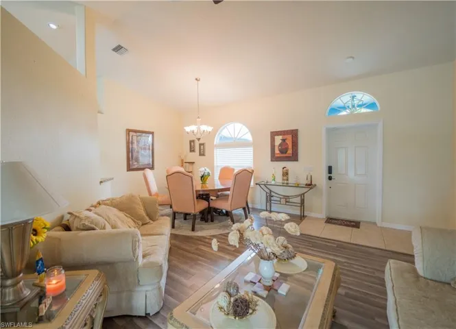 Front Living Room w/dark vinyl flooring & ceiling fan