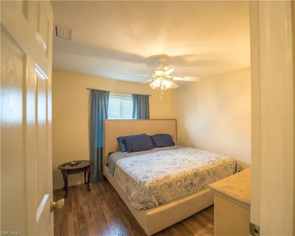 3rd Bedroom with ceiling fan and dark vinyl flooring
