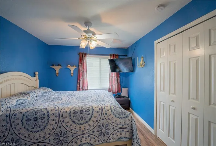 2nd Bedroom with ceiling fan and dark vinyl flooring