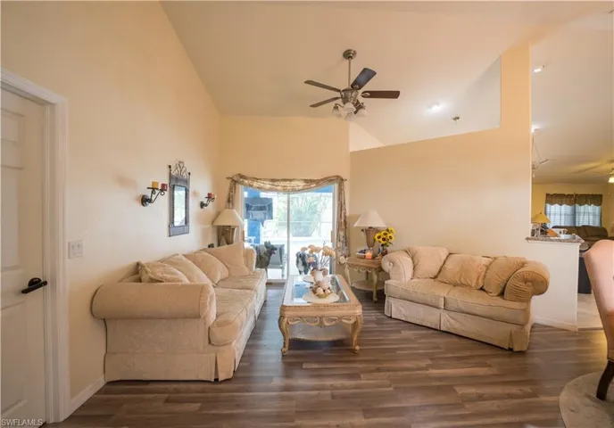 Front Living Room w/dark vinyl flooring & ceiling fan