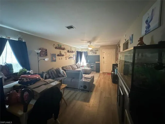 1023 Living room with ceiling fan and wood-type flooring