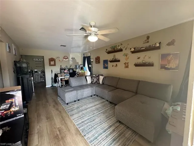 1023 Living room featuring ceiling fan and hardwood / wood-style flooring