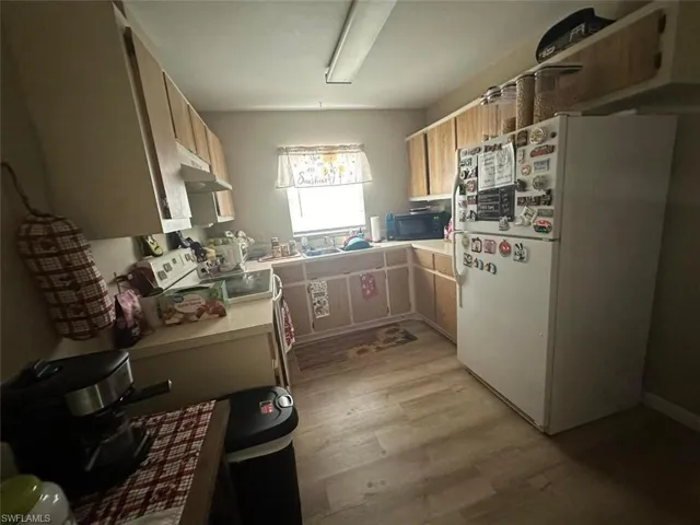 1023 Kitchen with light hardwood / wood-style floors and white appliances