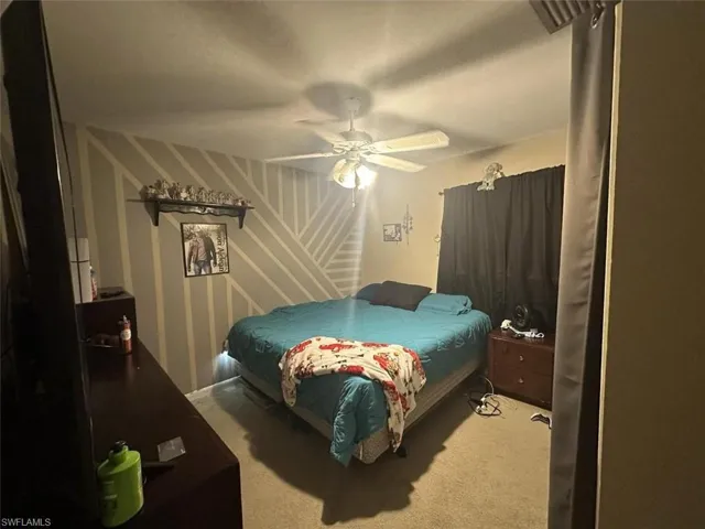 1023 Carpeted bedroom featuring ceiling fan