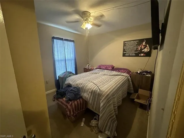 1023 Bedroom featuring carpet and ceiling fan