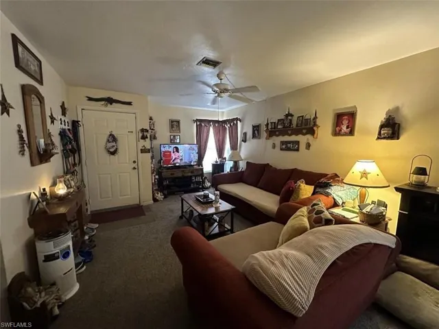 1021 Living room with dark carpet and ceiling fan
