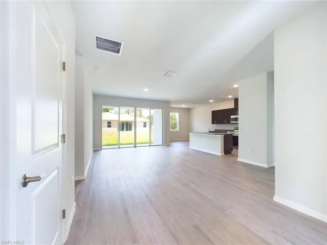 Unfurnished living room with light hardwood / wood-style floors