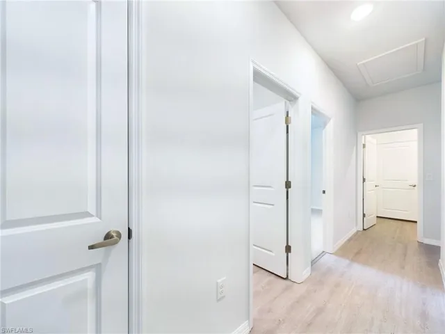Corridor featuring light wood-type flooring