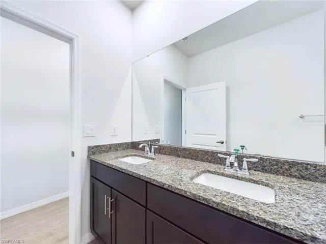 Bathroom with vanity and hardwood / wood-style floors