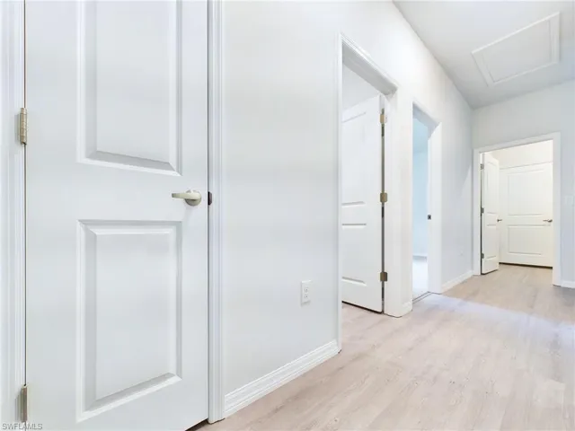 Hall featuring light wood-type flooring