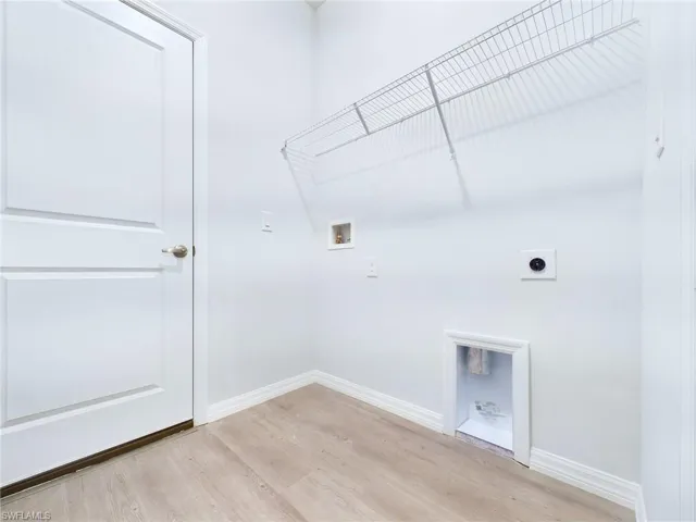 Washroom featuring washer hookup, light hardwood / wood-style floors, and electric dryer hookup