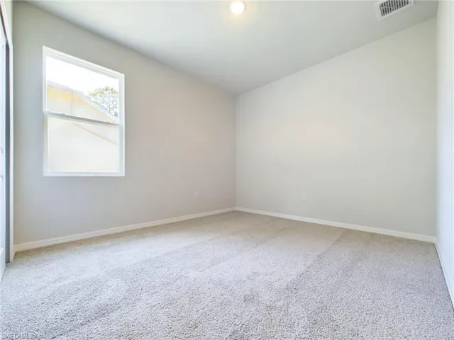 Unfurnished room with carpet