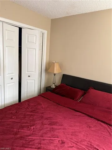 Bedroom featuring a closet and a textured ceiling