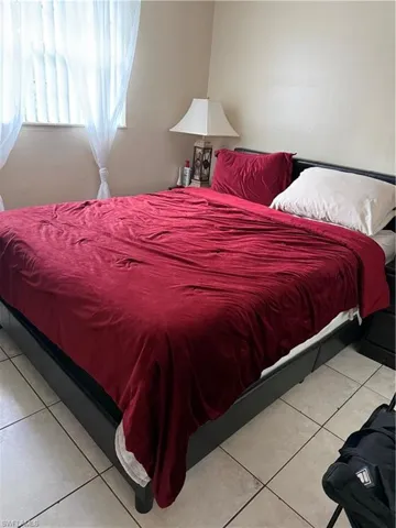 Bedroom with light tile patterned floors