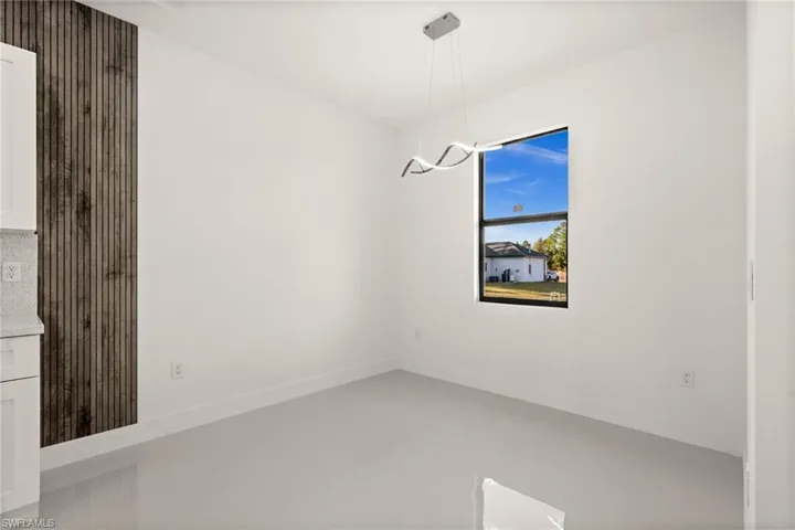 Unfurnished dining area with baseboards