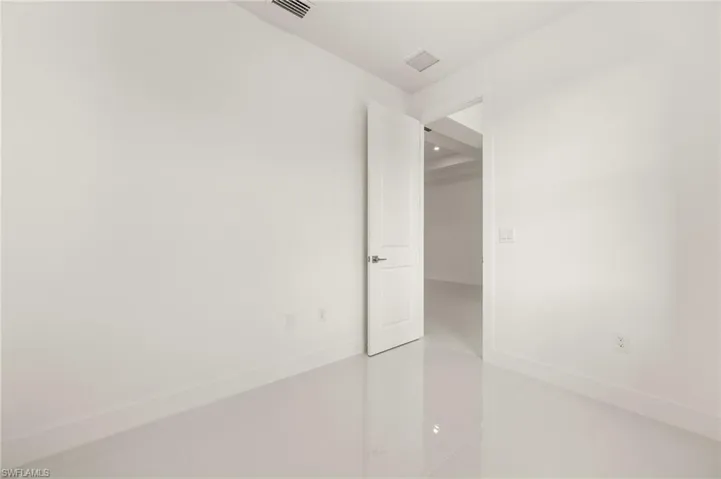 Unfurnished room featuring light tile patterned floors and baseboards