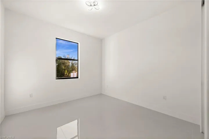 Unfurnished room with baseboards and tile patterned flooring