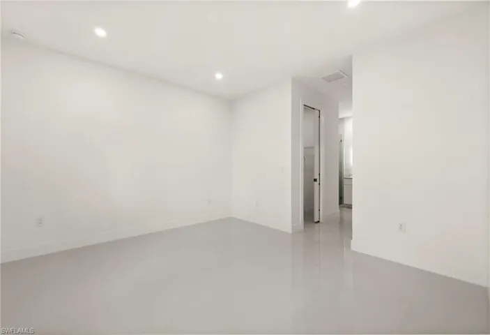 Empty room with recessed lighting and light tile patterned floors
