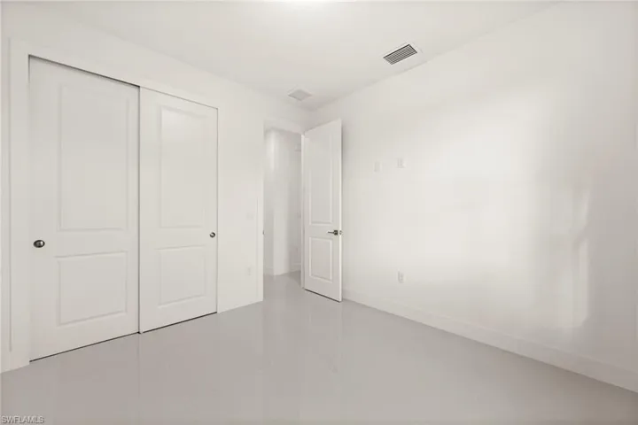 Unfurnished bedroom with a closet and light tile patterned flooring