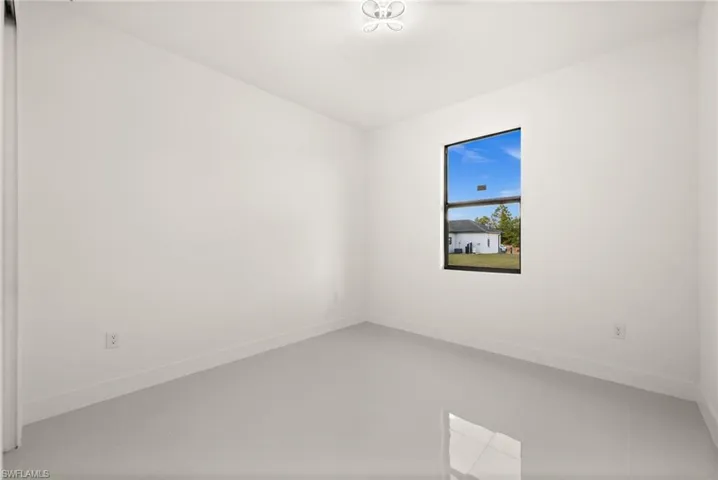 Spare room featuring baseboards