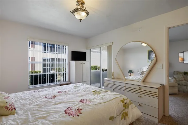 Bedroom featuring light carpet