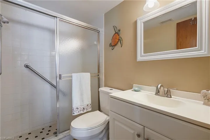 Full bath with vanity and a stall shower